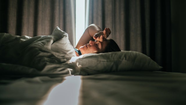 Woman awaking after sleeping well in a nice sleeping room. 
